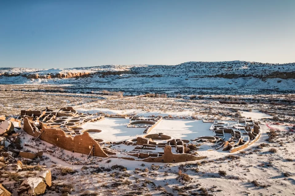 Native American ruins at Chaco Culture National Historical Park in winter with snow.